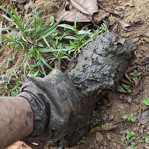 Boot caked in wet mud