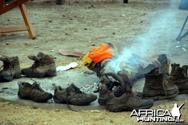 Hunting Shoes Drying Around Camp Fire