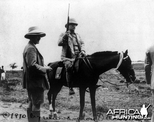 Theodore Roosevelt holding rifle on horseback in Africa, circa 1910