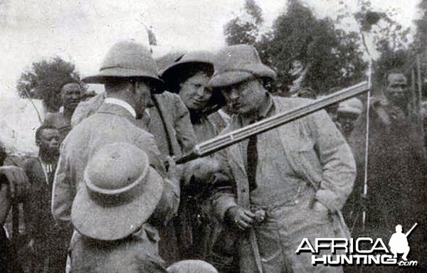 Theodore Roosevelt inspecting rifle with Kermit Roosevelt