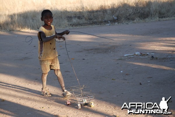 Little boy playing with his car, Namibia