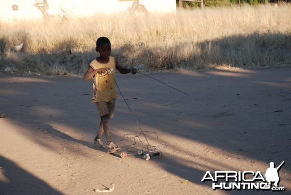 Boy playing with his car Namibia