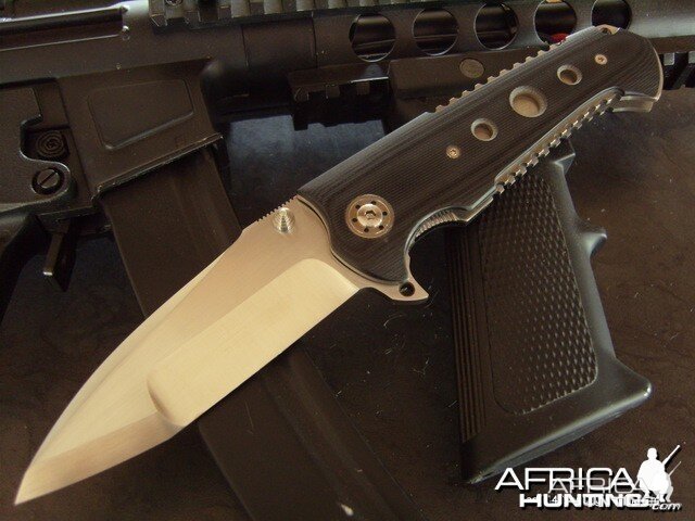 a tactical folding knife, with titanium and G10 frame