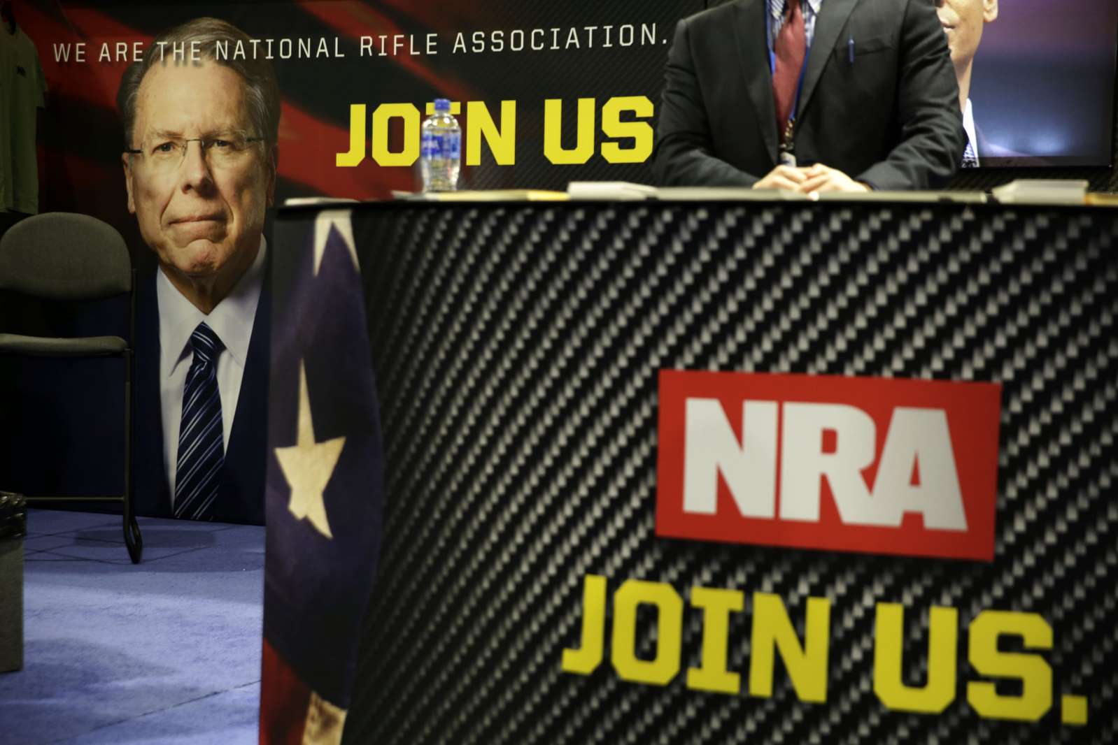 Wayne LaPierre wearing a suit and tie: The National Rifle Association (NRA) has filed for voluntary bankruptcy and vowed to reincorporate in Texas.