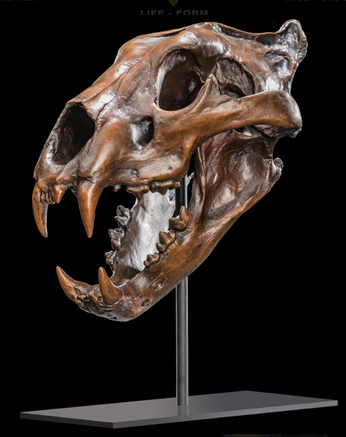 bronzed lion skull on stand.png