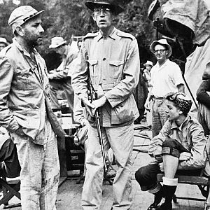 Huston holding Mannlicher Schönauer, with Bogart and Bacall