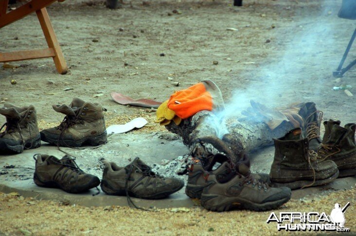 Hunting Shoes Drying Around Camp Fire