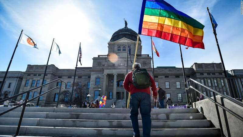 FILE - In this March 15, 2021, file photo demonstrators gather on the step of the Montana State Capitol protesting anti-LGBTQ+ legislation in Helena, Mont. The Montana Senate Judiciary Committee voted Thursday, March 18 to advance two bills targeting transgender youth despite overwhelming testimony opposing the measures. The measures would ban gender affirming surgeries for transgender minors and ban transgender athletes from participating in school and college sports. Both bills have already passed the Montana House. They head next to votes by the GOP-controlled Montana Senate. (Thom Bridge/Independent Record via AP, File)