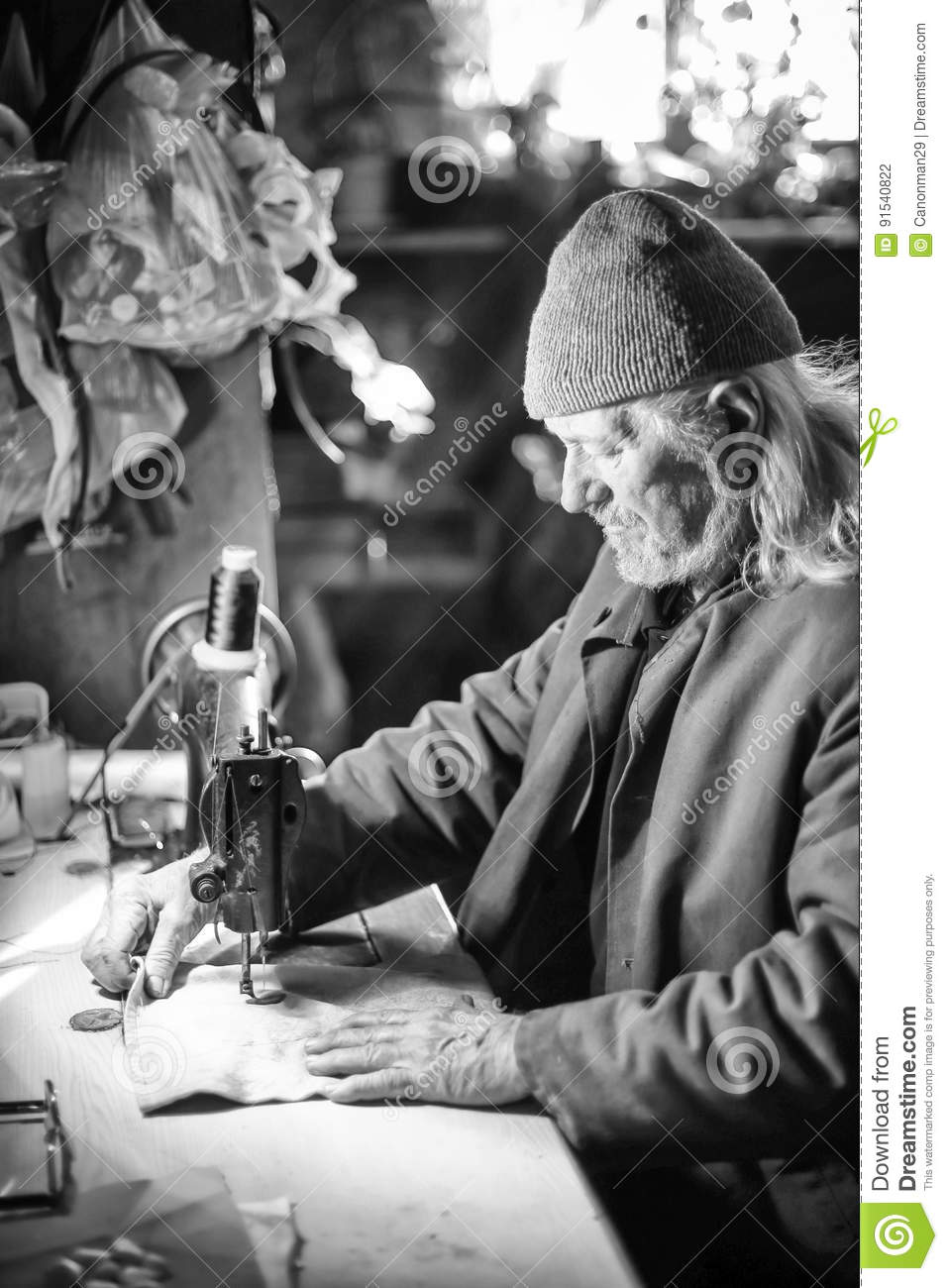 old-man-sewing-bw-senior-adult-piece-cloth-machine-91540822.jpg